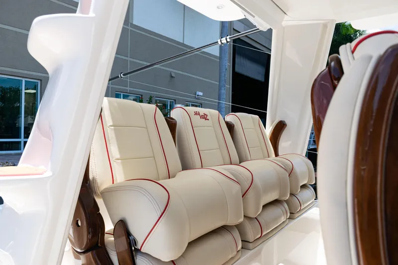  Yacht Photos Pics Luxurious seating on 2022 SeaVee 450z boat with cream upholstery and red accents.