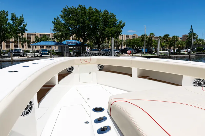  Yacht Photos Pics 2022 SeaVee 450z boat interior with cushioned seating and waterfront view.