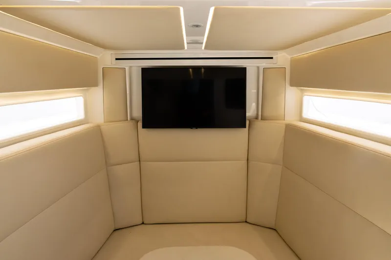  Yacht Photos Pics Luxurious interior of 2022 SeaVee 450z boat with beige seating and mounted TV.