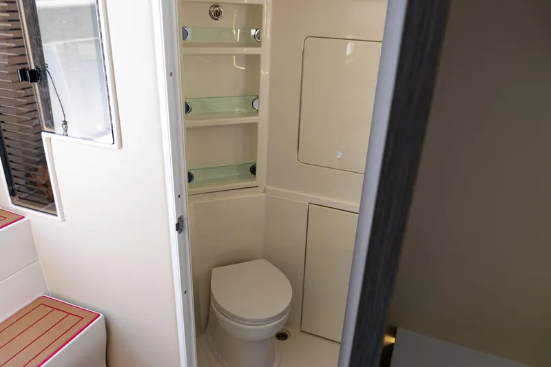  Yacht Photos Pics 2022 SeaVee 450z boat interior bathroom with toilet and shelves.