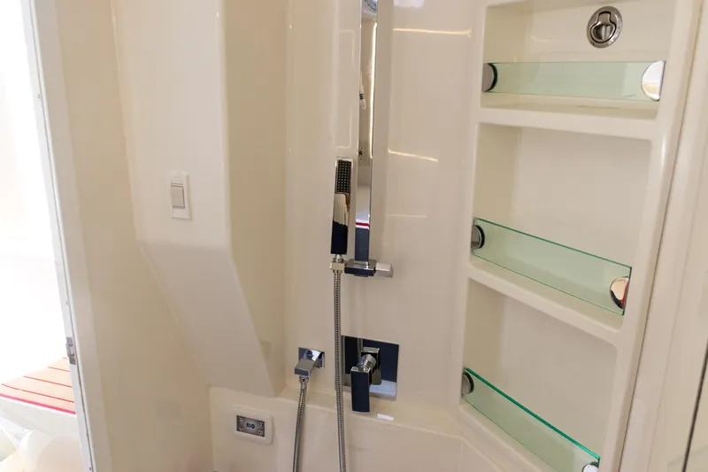  Yacht Photos Pics Luxurious bathroom interior of 2022 SeaVee 450z boat with modern shower fixtures.
