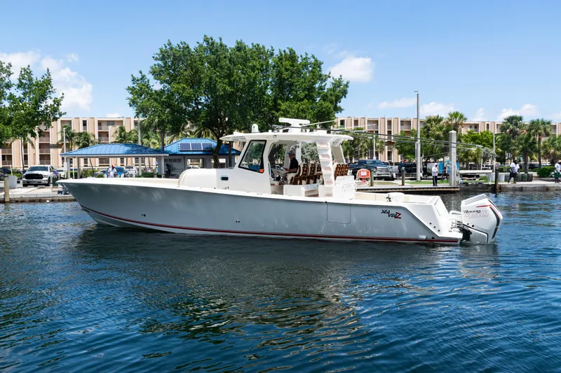  Yacht Photos Pics 2022 SeaVee 450z boat docked in a marina, featuring sleek design and powerful engines.