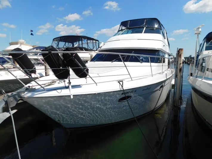  Yacht Photos Pics 2002 Carver 450 Voyager Pilothouse yacht docked at marina under blue sky.