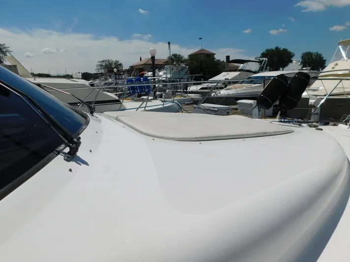  Yacht Photos Pics 2002 Carver 450 Voyager Pilothouse yacht docked at marina under clear blue sky.