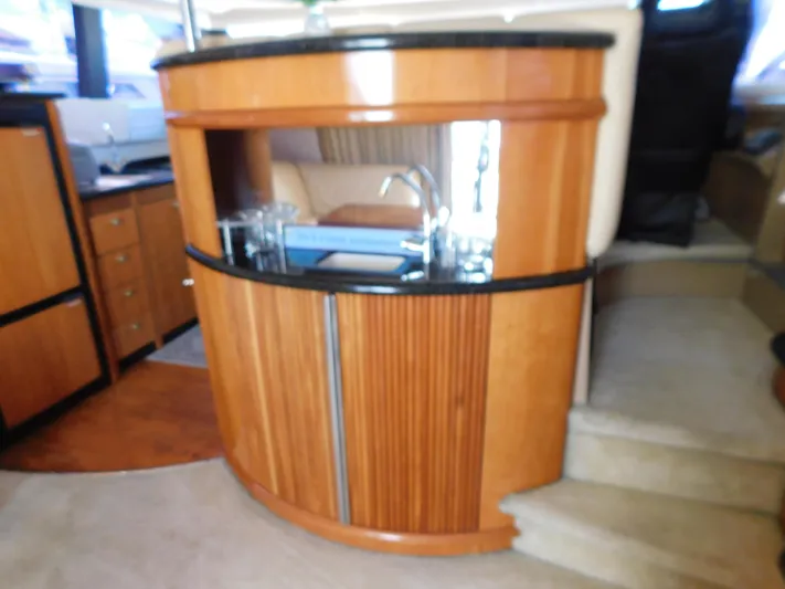  Yacht Photos Pics Luxurious interior of 2002 Carver 450 Voyager Pilothouse with wooden cabinetry and modern amenities.