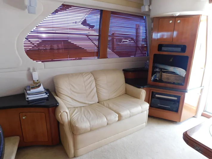  Yacht Photos Pics Interior of 2002 Carver 450 Voyager Pilothouse with beige sofa and wooden cabinetry.