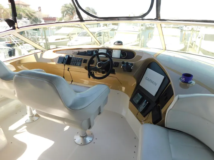  Yacht Photos Pics Pilothouse interior of 2002 Carver 450 Voyager with Garmin navigation system and dual captain chairs.