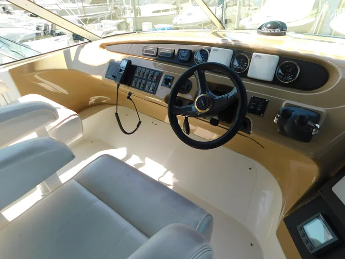  Yacht Photos Pics Interior of 2002 Carver 450 Voyager Pilothouse, featuring helm controls and seating.