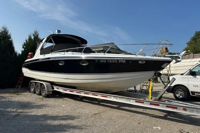  Yacht Photos Pics 2008 Formula 330 Sun Sport boat on trailer, parked outdoors under clear sky.