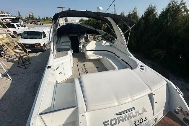  Yacht Photos Pics 2008 Formula 330 Sun Sport boat with spacious seating and sleek design, docked outdoors.