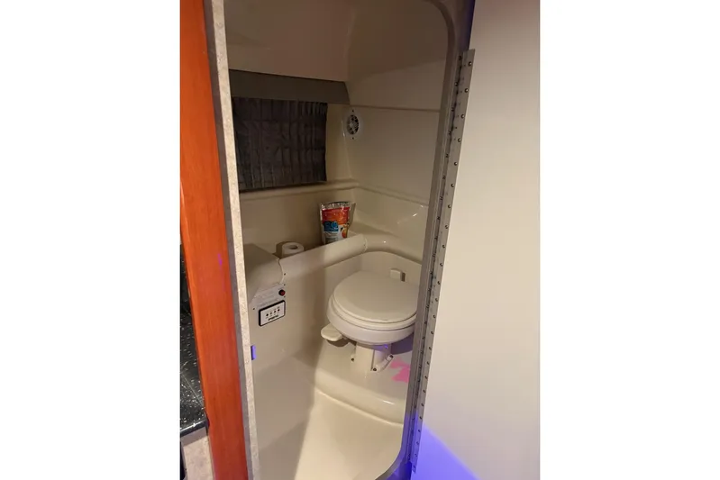  Yacht Photos Pics Compact bathroom in 2008 Formula 330 Sun Sport boat, featuring a toilet and storage space.