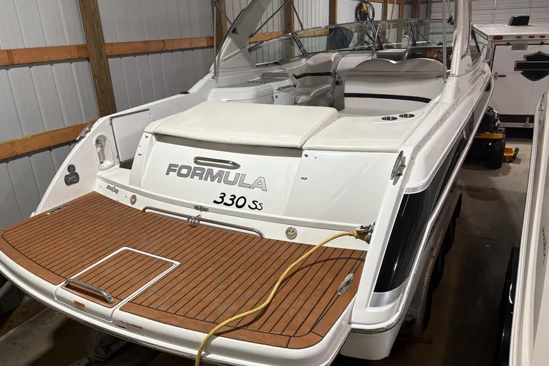  Yacht Photos Pics 2008 Formula 330 Sun Sport boat in storage, featuring teak swim platform.