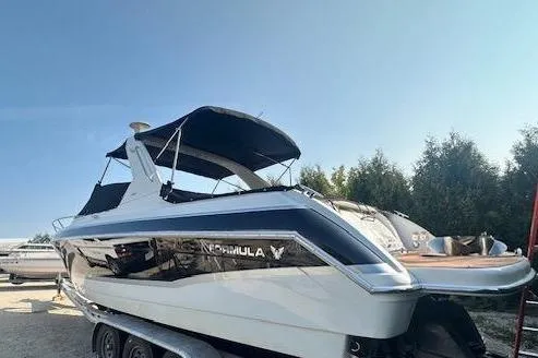  Yacht Photos Pics 2008 Formula 330 Sun Sport boat on trailer, parked outdoors under clear sky.