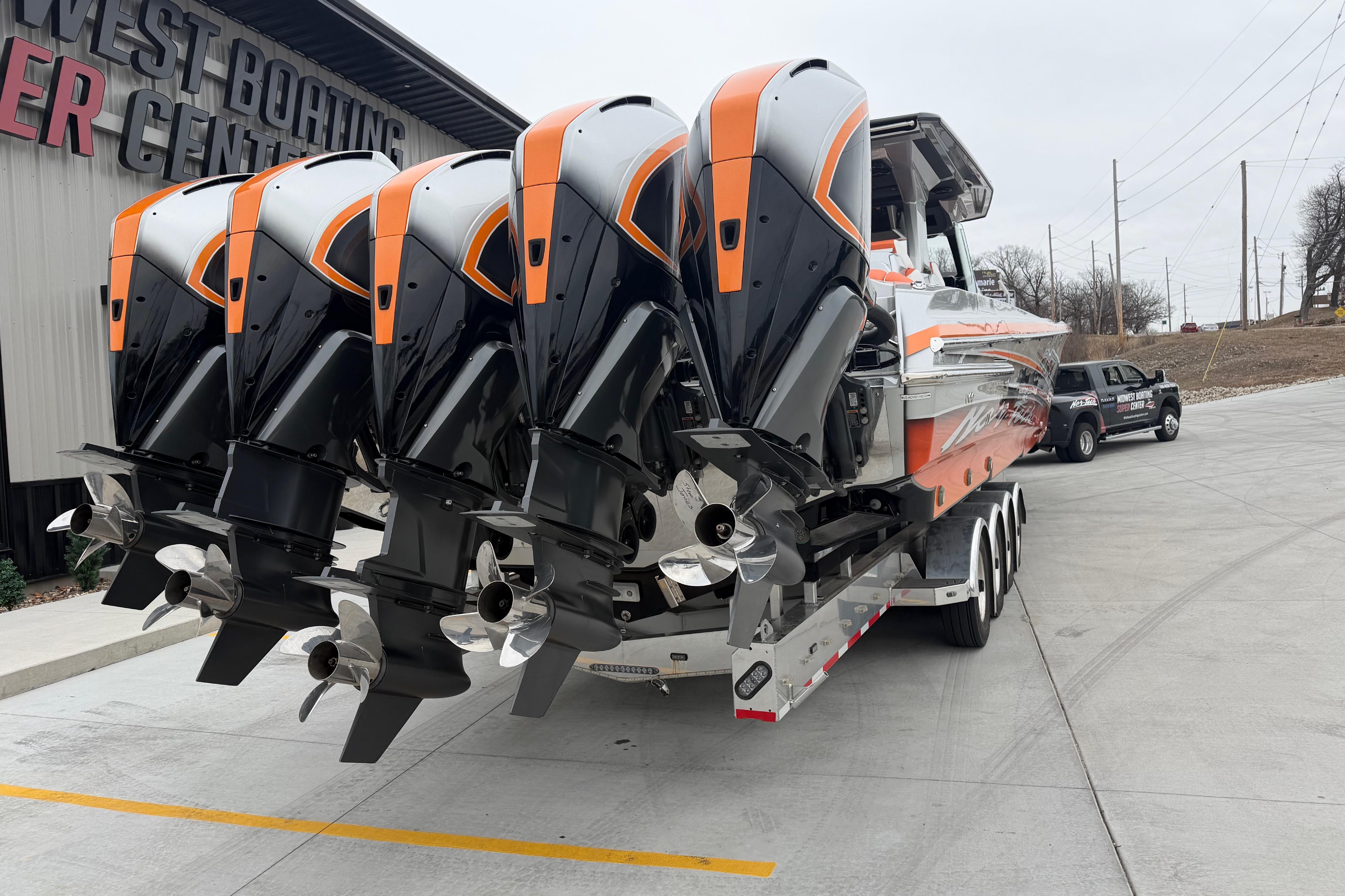 2024 Nor-Tech 500 Sport Center Console with quad engines at a boating center.