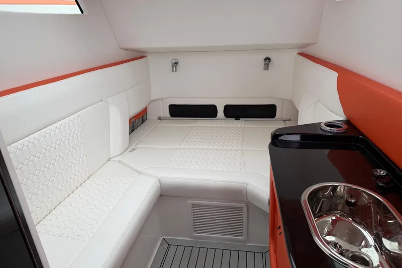  Yacht Photos Pics 2024 Nor-Tech 500 Sport Center Console cabin with white seating and sleek sink area.