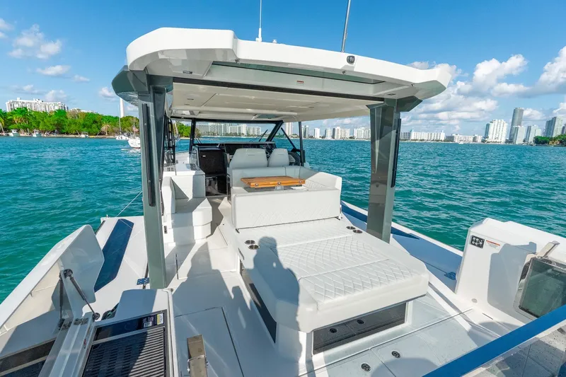  Yacht Photos Pics 2025 Saxdor 400 GTO luxury yacht on water with city skyline backdrop.