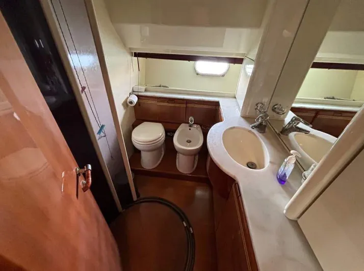 Yacht Photos Pics Bathroom interior of 2001 Ferretti Yachts 80 RPH, featuring sink, toilet, and bidet.