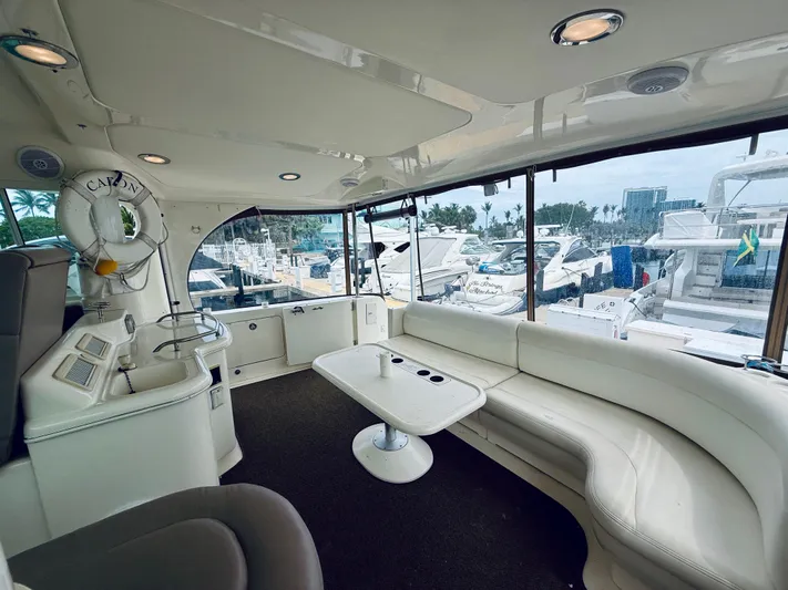  Yacht Photos Pics Interior of 2003 Sea Ray 480 Motor Yacht with white seating and marina view.