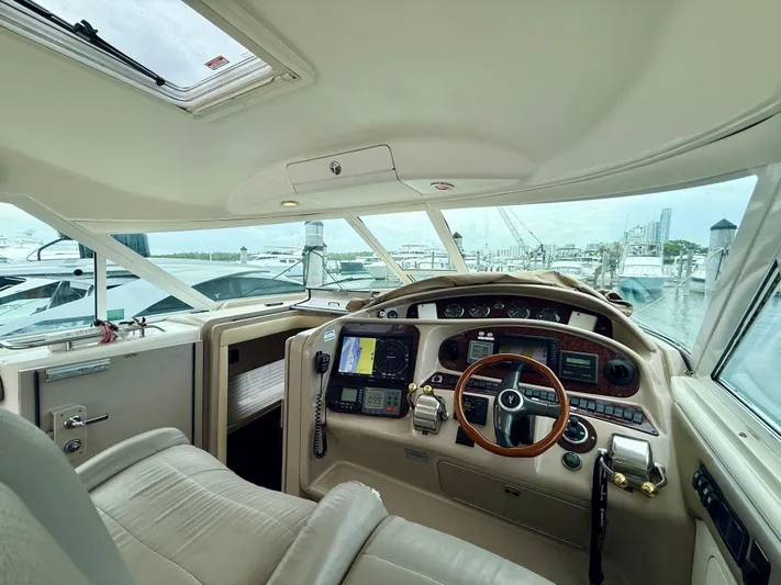  Yacht Photos Pics 2003 Sea Ray 480 Motor Yacht helm with navigation equipment and marina view.