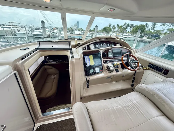  Yacht Photos Pics Interior view of 2003 Sea Ray 480 Motor Yacht helm with navigation equipment and seating.