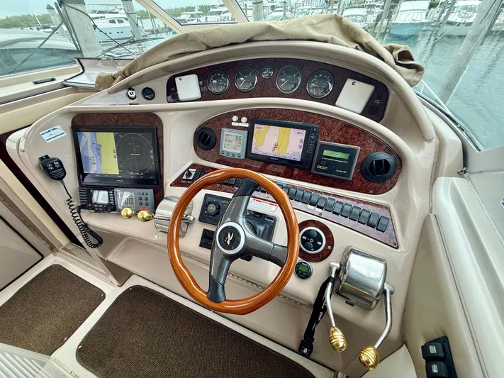  Yacht Photos Pics 2003 Sea Ray 480 Motor Yacht helm with navigation instruments and wooden steering wheel.
