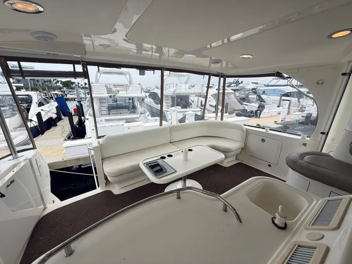  Yacht Photos Pics Interior of 2003 Sea Ray 480 Motor Yacht with white seating and marina view.