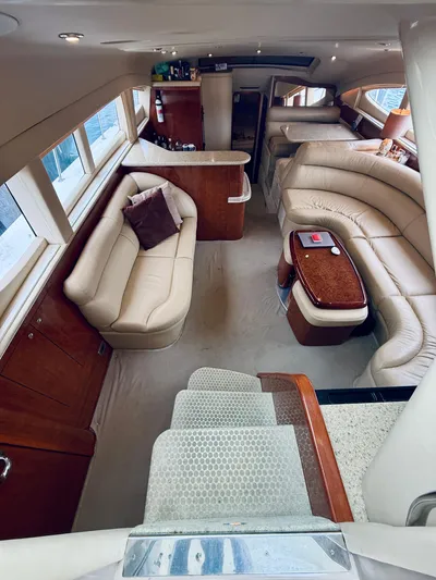  Yacht Photos Pics Luxurious interior of 2003 Sea Ray 480 Motor Yacht with plush seating and elegant wood finishes.