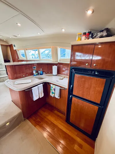  Yacht Photos Pics 2003 Sea Ray 480 Motor Yacht kitchen with wood cabinetry and modern appliances.