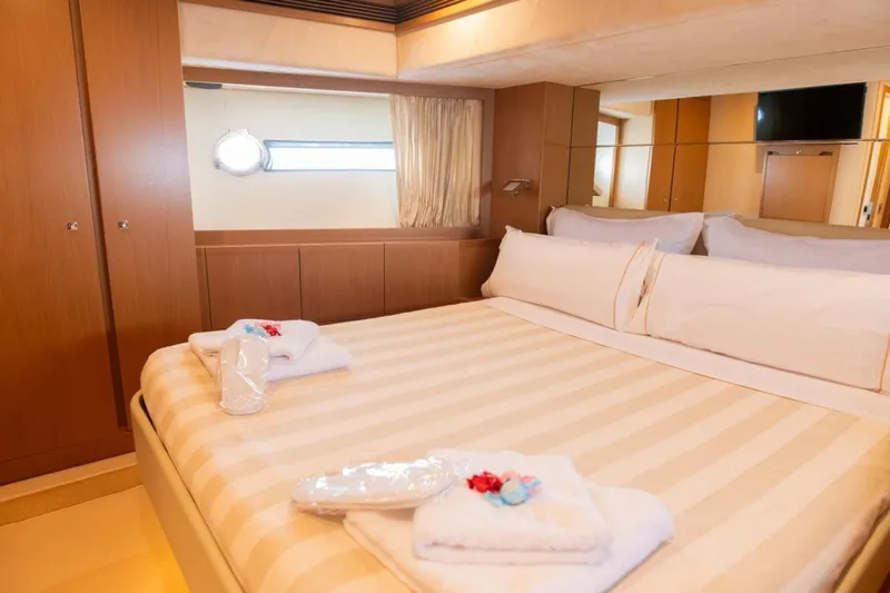  Yacht Photos Pics Luxurious bedroom interior of 2006 Ferretti 780 yacht with elegant bedding and wooden accents.