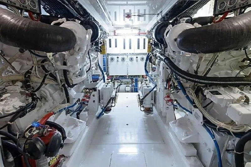 Show Time Yacht Photos Pics Engine room of 2007 Hatteras 68 Convertible yacht, showcasing dual engines and mechanical systems.