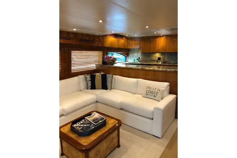 Show Time Yacht Photos Pics Luxurious interior of 2007 Hatteras 68 Convertible yacht with white sofa and wooden accents.