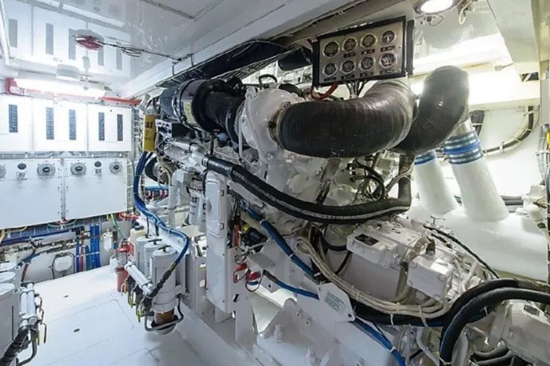 Show Time Yacht Photos Pics Engine room of 2007 Hatteras 68 Convertible yacht, showcasing complex machinery and control panels.