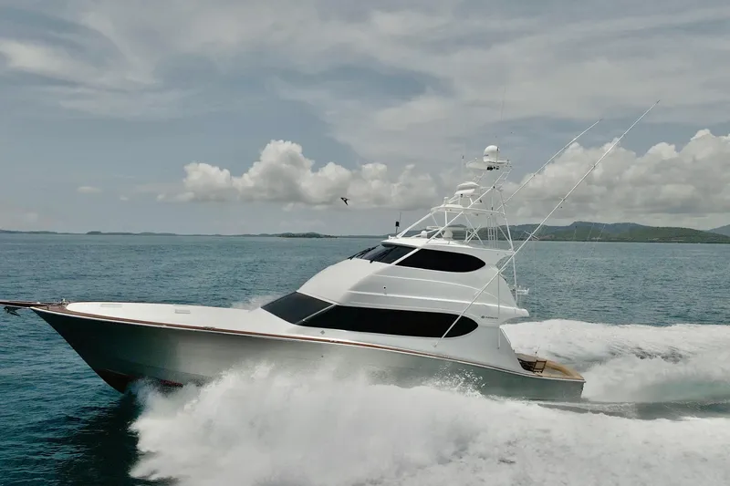 Show Time Yacht Photos Pics 2007 Hatteras 68 Convertible yacht cruising on open water under a cloudy sky.