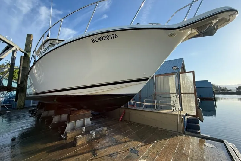 Good Fun Yacht Photos Pics 2006 Pursuit 3370 Offshore boat on dry dock, side view, sunny day.