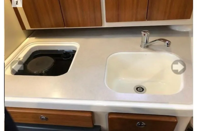 Good Fun Yacht Photos Pics 2006 Pursuit 3370 Offshore boat kitchen with sink and stove.