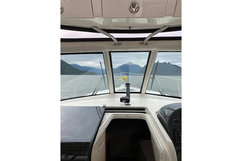 Good Fun Yacht Photos Pics 2006 Pursuit 3370 Offshore boat interior with scenic mountain view through windshield.