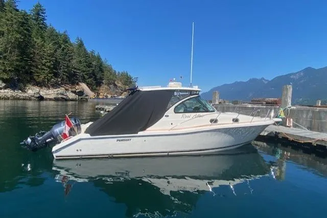 Good Fun Yacht Photos Pics 2006 Pursuit 3370 Offshore boat docked in scenic marina with mountains.