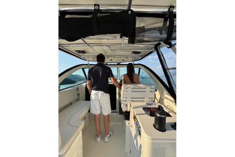 Good Fun Yacht Photos Pics 2006 Pursuit 3370 Offshore boat interior with two people enjoying the view.