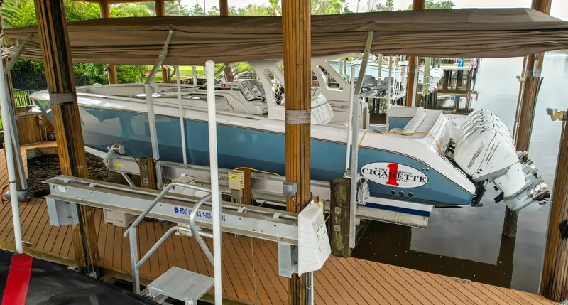  Yacht Photos Pics 2015 Cigarette 42 Huntress boat docked under a canopy.