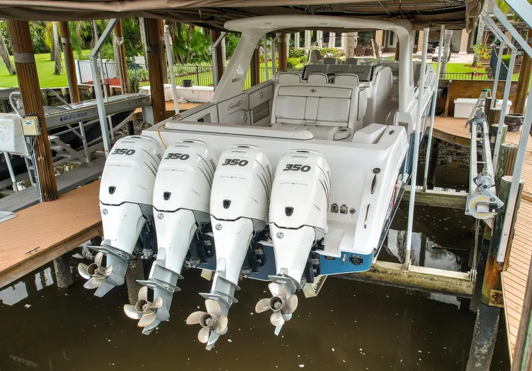  Yacht Photos Pics 2015 Cigarette 42 Huntress boat with four powerful outboard engines docked in a marina.