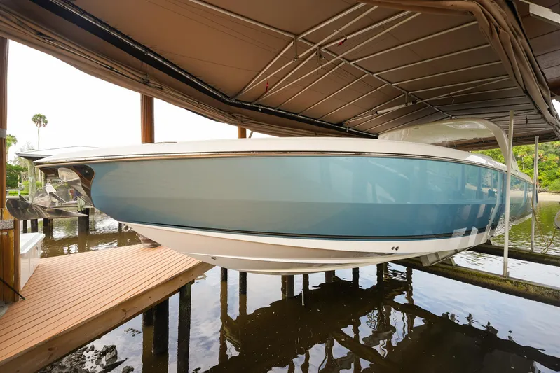  Yacht Photos Pics 2015 Cigarette 42 Huntress boat docked under a covered structure.