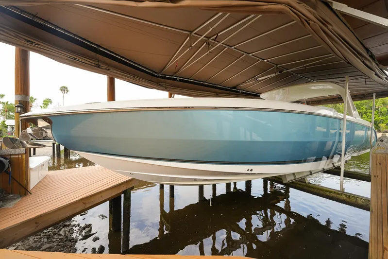  Yacht Photos Pics 2015 Cigarette 42 Huntress boat docked under a canopy.