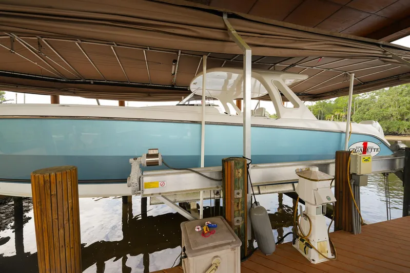  Yacht Photos Pics 2015 Cigarette 42 Huntress boat docked under a covered marina.