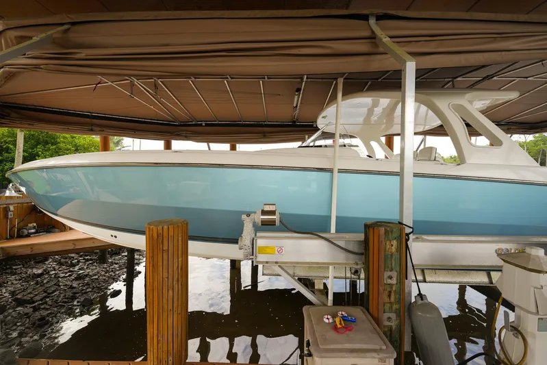  Yacht Photos Pics 2015 Cigarette 42 Huntress boat in dock, side view, under canopy.
