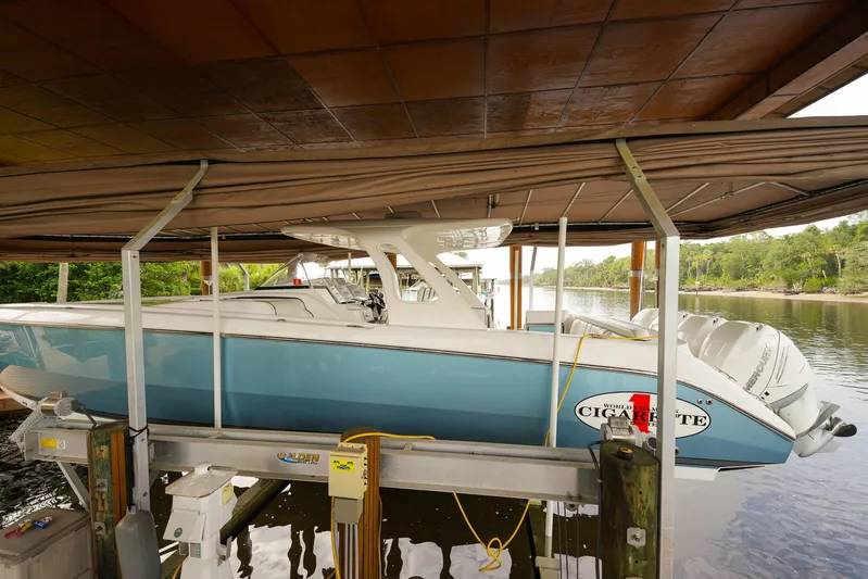  Yacht Photos Pics 2015 Cigarette 42 Huntress boat docked under a covered marina.
