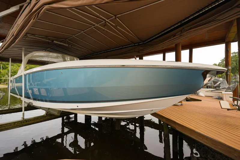  Yacht Photos Pics 2015 Cigarette 42 Huntress boat docked under a canopy, side view.