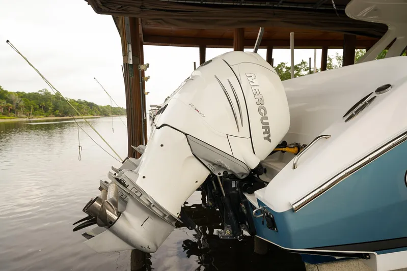  Yacht Photos Pics 2015 Cigarette 42 Huntress boat with Mercury outboard motor docked by a river.