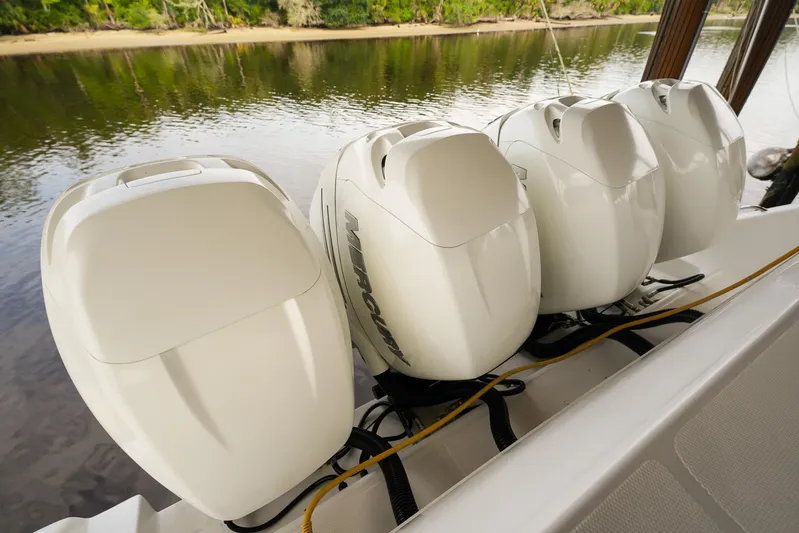  Yacht Photos Pics Four powerful outboard engines on a 2015 Cigarette 42 Huntress boat by a river.