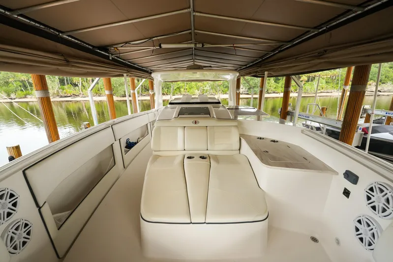  Yacht Photos Pics 2015 Cigarette 42 Huntress boat interior with white seating under a canopy.