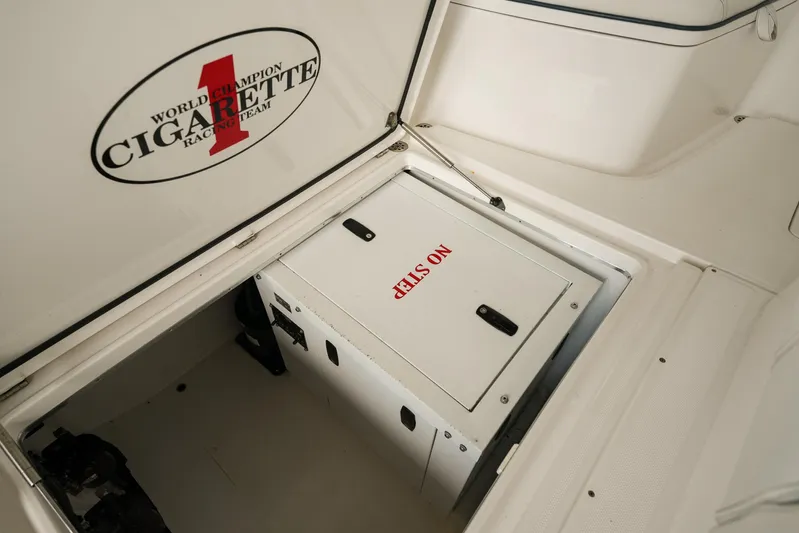  Yacht Photos Pics 2015 Cigarette 42 Huntress boat storage compartment with "No Step" warning label.